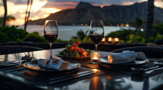 A plated course on a dark table in a Honolulu high-rise at dusk